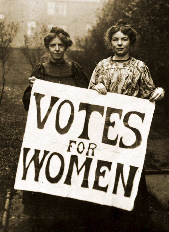 Annie Kenney and Christabel Pankhurst holding a 'Votes for Women' banner