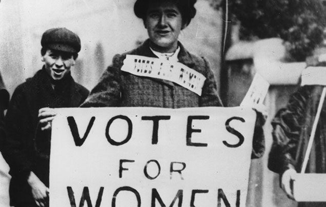 Suffragette campaigner with 'Votes for Women' placard